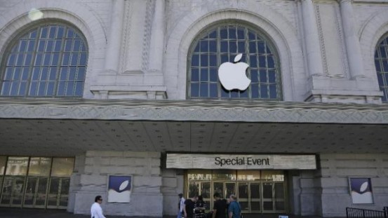 A crew works outside the Bill Graham Civic Auditorium as preparations continue for the Apple new product announcements (AP)